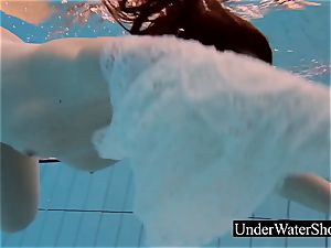 spectacular ginger-haired in the milky dress underwater